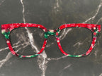 snowflakes against a green and red background giving a winter and Christmas vibe for metal toppers for Pair Eyewear top frames